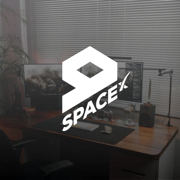 9SpaceX logo over a modern office desk setup with computer monitors and decor.