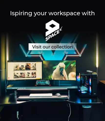 Modern workspace setup with computer monitors and desk, featuring SpaceX logo and text.